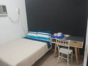 a bedroom with two beds and a desk and a chair at Lo de Dolly in Tartagal