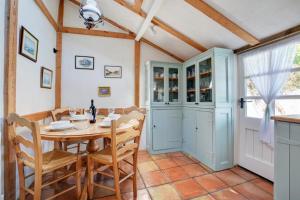 a dining room with a table and chairs at The Old Coach House in Cawston