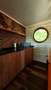 a kitchen with a counter and a window at Wayra Tiny Cabin Pupuya in Pupuya +7 photos