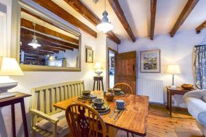 a living room with a wooden table and chairs at Mundles Cottage in Whittingham
