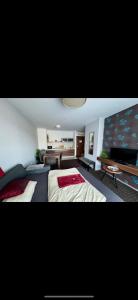a bedroom with two beds and a living room at Happy Seasons Szoboszló in Hajdúszoboszló