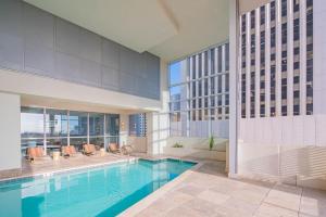 a swimming pool in a building with a building at Bright & Stylish 2BR High-Rise Pool Gym Access in Phoenix