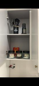 a kitchen shelf with dishes and utensils on it at Ap Royal Mirage in Florianópolis