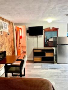 Una sala de estar con cocina y comedor. en Travelers Inn Olney, en Olney