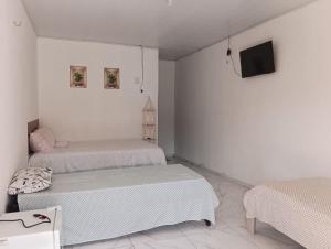 Кровать или кровати в номере Pousada raio de sol