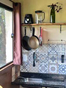 a kitchen with a sink and a tile counter top at Loft Urucum in Palmeiras