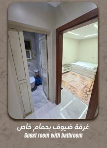 a bathroom with a mirror and a room with a bed at An Apartment in Kenz Compound, October - Very close to the pyramids in ‘Ezbet `Abd el-Ḥamîd