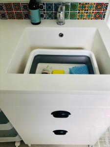 a white kitchen sink with a drawer in it at The Perch in Albert Town +14 photos