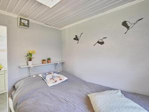 a bedroom with a bed with birds on the wall at Ooievaarsnest in Laakdal