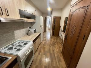 a kitchen with a stove and a counter top at Уютный дом in Yerevan