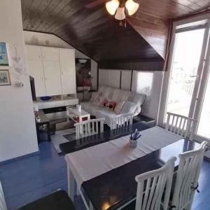 a living room with a couch and a table and chairs at Apartment in Crikvenica 53539 in Sopaljska +8 photos