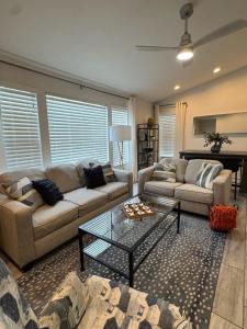 a living room with two couches and a coffee table at Swamp Side Stay in Gainesville