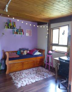 a room with a bed and a desk in a room at Casa Bosque Encantador in Rancho Queimado