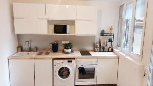 a kitchen with a washing machine and a sink at Studio MAREVA in Cavaillon