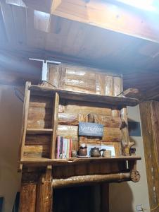 a shelf made out of logs with books on it at Sea of clouds view inn in Sagada