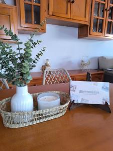 a kitchen counter with a vase and a box on a table at Casa Torrox Costa cerca del mar in Torrox