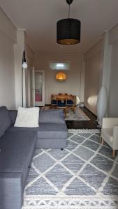 a living room with a couch and a table at Acropolis View Condo, perfect location! in Piraeus