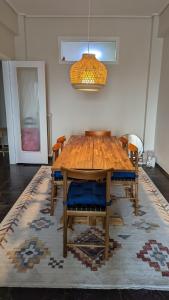 a dining room table with chairs and a chandelier at Acropolis View Condo, perfect location! in Piraeus