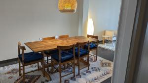 a wooden table and chairs in a room at Acropolis View Condo, perfect location! in Piraeus +22 photos