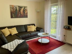 a living room with a couch and a table at in the Lenzer Höh I holiday park in Lenz