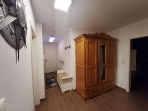 a bathroom with a wooden cabinet in a room at Holiday apartment with 2 bedrooms in Sassnitz +25 photos