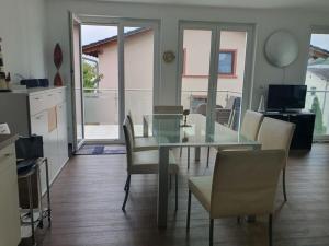 a dining room with a glass table and chairs at Holiday apartment with 2 bedrooms in Sassnitz