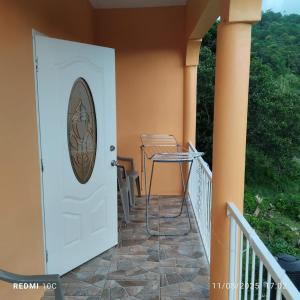 a white door with a window on a balcony at DeDe's Place in Babonneau +9 photos