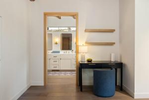 a bathroom with a vanity and a desk and a mirror at Oaks & Madeira A Luxury Wine Escape in Paso Robles in Paso Robles +53 photos