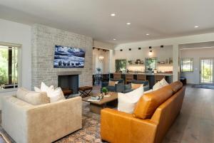 a living room with a couch and a fireplace at Oaks & Madeira A Luxury Wine Escape in Paso Robles in Paso Robles