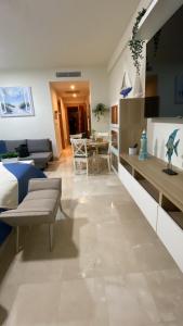 a living room with a couch and a table at Apartamento en Puerto Plata Marien Residences in Puerto Plata
