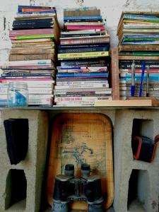 a pile of books sitting on top of a table at Huanchaco Surf Camp in Huanchaco