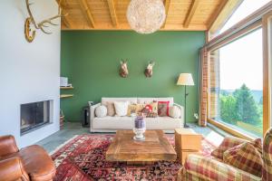a living room with a couch and a table at Edelweiss Ferienwohnung, Las Fluras Alpine Penthouse in Flims