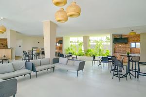 a lobby with couches and tables and chairs at Sunset Brightness in a 1Bdrm Apt. in Punta Cana in Punta Cana