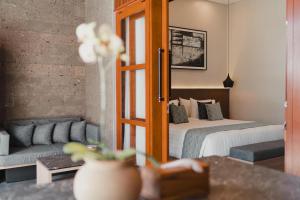 a hotel room with a bed and a couch at Dikubu Belong VILLA in Denpasar +44 photos