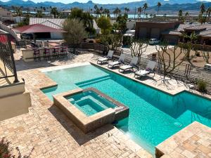 an overhead view of a swimming pool in a resort at Luxury Estate in Prime Location w Panoramic views of Lake Havasu in Lake Havasu City