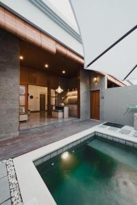 an indoor pool in the backyard of a house at Dikubu Belong VILLA in Denpasar