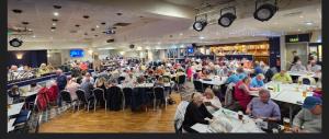 a crowd of people sitting at tables in a restaurant at Reads Avenue 1 Bed Apartment - Next To H&A Social Club - Minutes from Winter Gardens & Town Centre! in Blackpool