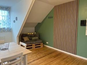 a living room with a couch and a table at Bienvenue chez Marie et Guillaume in Carentan +8 photos