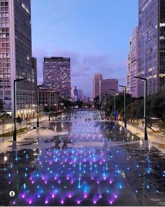 a fountain in the middle of a city with buildings at Studio Aconchego - 2 Bedrooms with Wi-Fi Subway in Sao Paulo