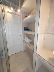 Un baño con ducha y puerta de cristal. en The Dreams Palace, en Porto San Paolo