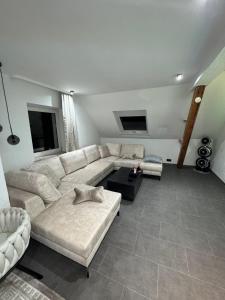 a living room with a couch and a table at Ays-SPA, Whirlpool & Sauna in Iserlohn