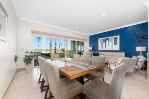 a dining room with a table and chairs at Condo Paraiso - Luxurious new condo 300mt from the beach in Cabo San Lucas