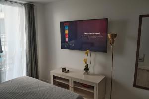 a bedroom with a flat screen tv on the wall at M&R Condotel Azure North in San Fernando