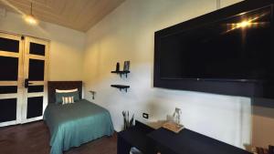 a living room with a large flat screen tv on the wall at Casa Mosaiko Sonsón in Sonsón +12 photos