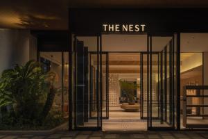 an entrance to a building with a sign that reads the nest at THE NEST NAHA in Naha