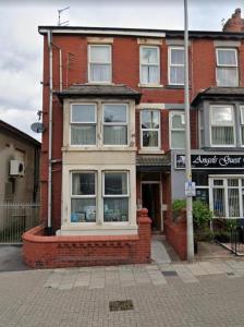 a brick building with windows on a city street at Reads Avenue 1 Bed Apartment - Next To H&A Social Club - Minutes from Winter Gardens & Town Centre! in Blackpool