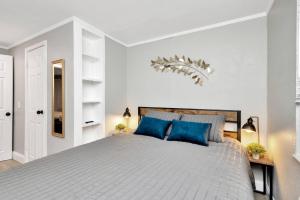 a bedroom with a large bed with blue pillows at Newly Updated Modern 1-Bedroom Private Guesthouse in Clearwater