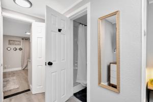 a hallway with a mirror and a white door at Newly Updated Modern 1-Bedroom Private Guesthouse in Clearwater +18 photos