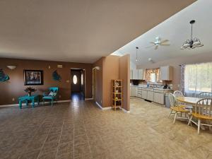 a large living room with a table and a kitchen at Casita La Mesilla in Espanola