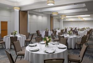 a banquet room with white tables and chairs at Holiday Inn Jacksonville E 295 Baymeadows by IHG in Jacksonville +33 photos